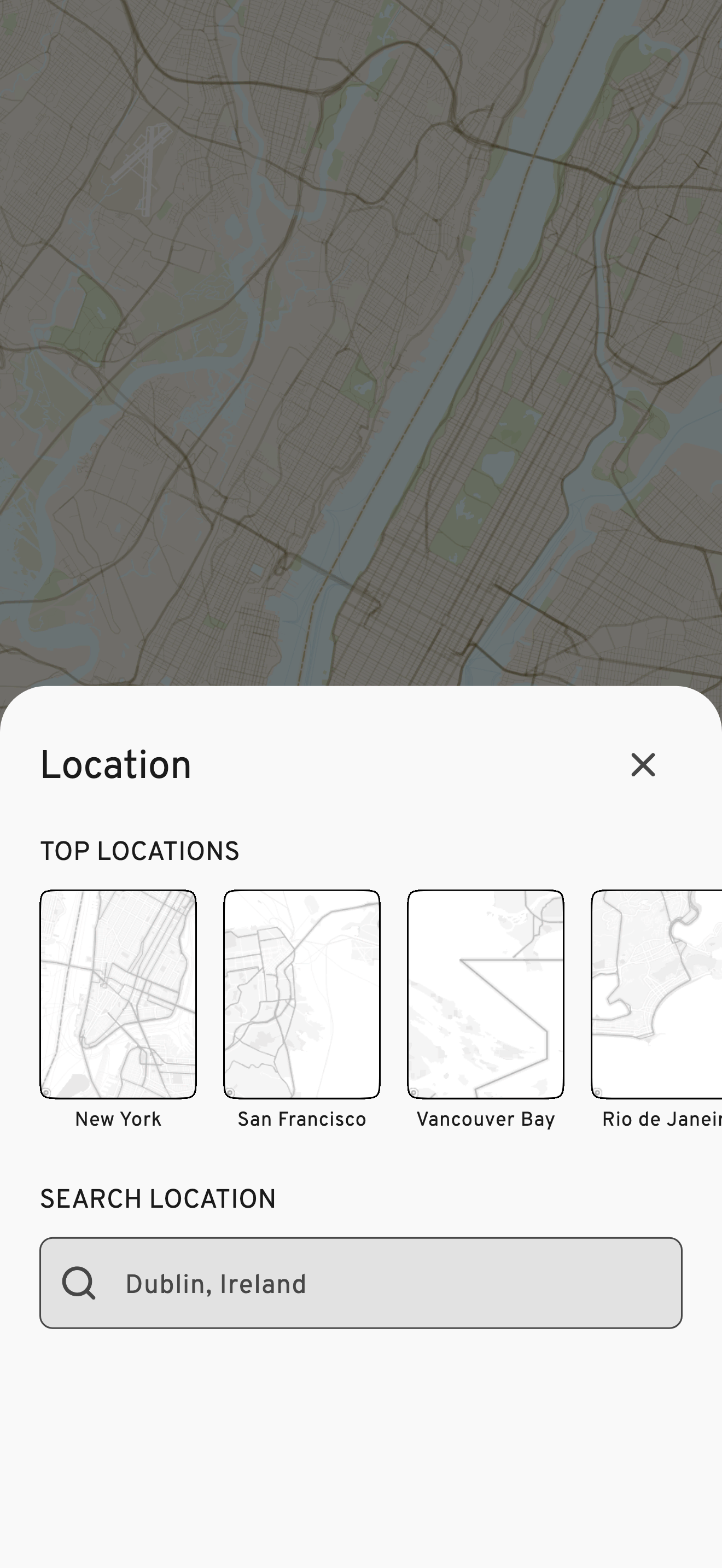 The current WMap location screen: a light sheet titled Location over a dimmed New York map, with Top Locations thumbnails for New York, San Francisco, Vancouver Bay and Rio de Janeiro, and a search field with Dublin, Ireland typed in