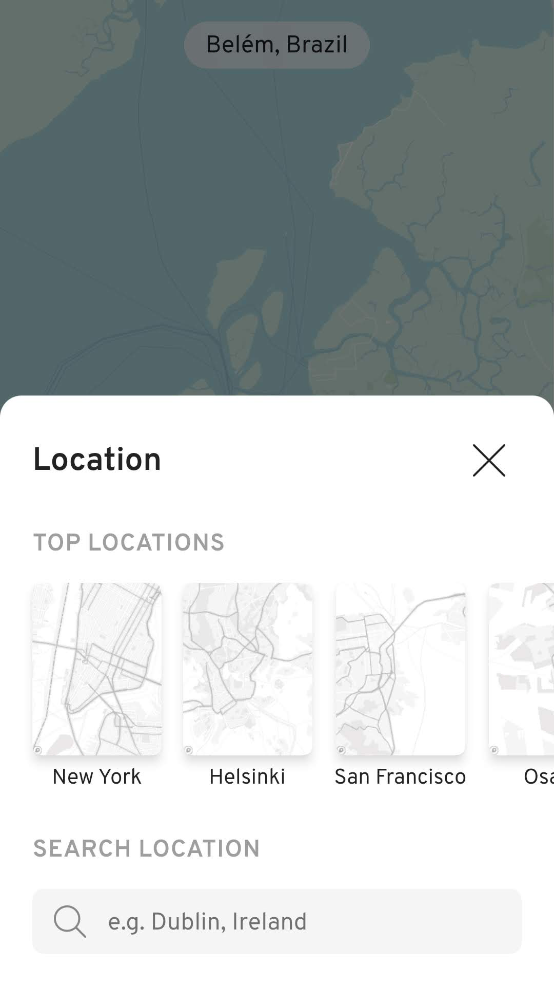 The original WMap location screen: a dark sheet titled Location over a dimmed blue-green map of Belém, Brazil, with grey Top Locations thumbnails for New York, Helsinki and San Francisco and a placeholder search field reading e.g. Dublin, Ireland