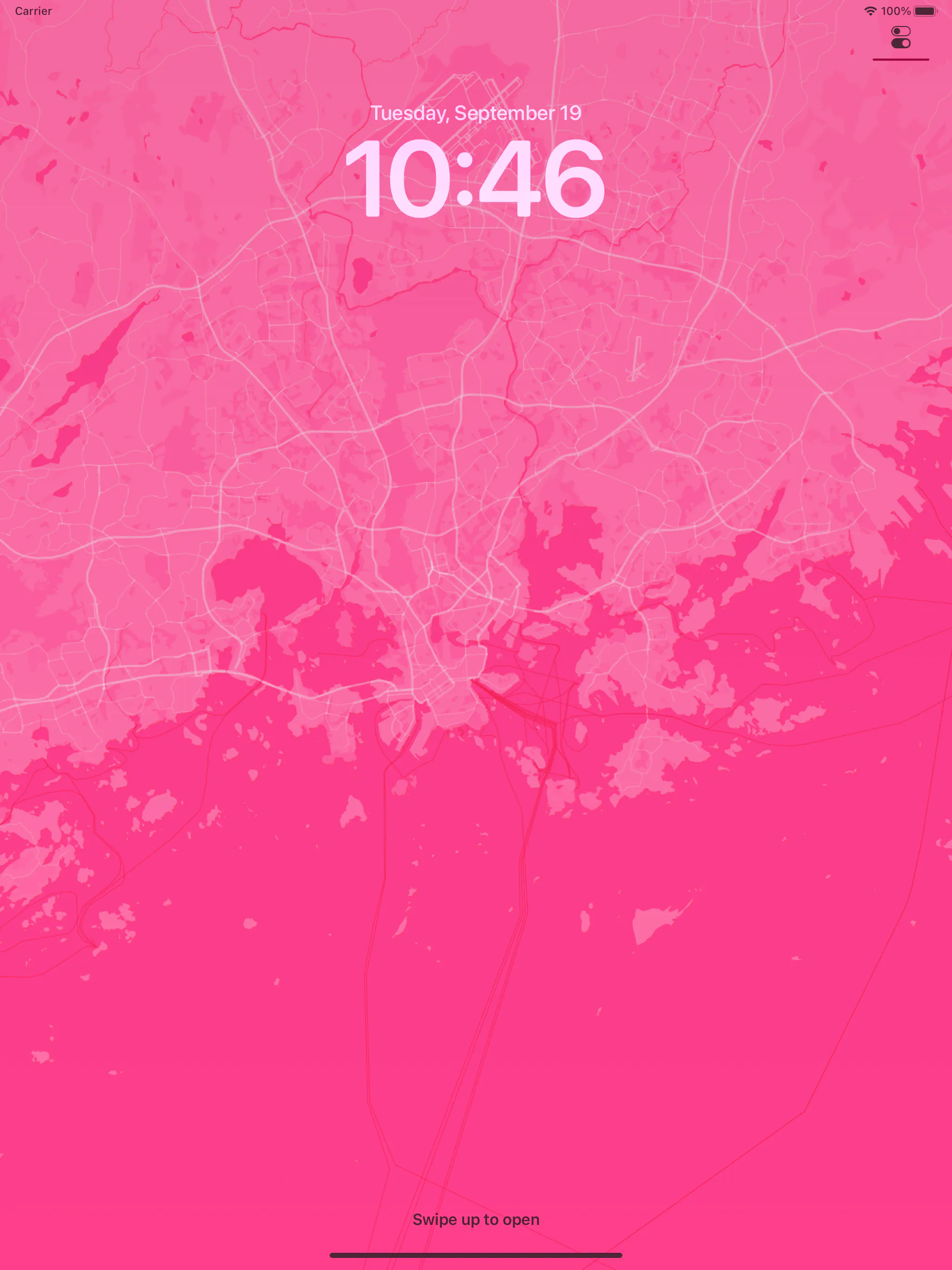 An iPad lock screen with a vivid pink WMap wallpaper of a city and its harbour, with pink map lines and land shapes filling the screen