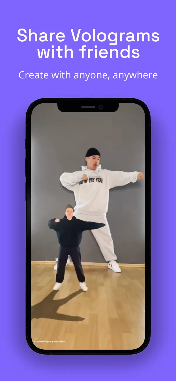 Shared vologram video on a phone screen: a large reconstructed man in white and a smaller woman in black dancing tango together in the same room
