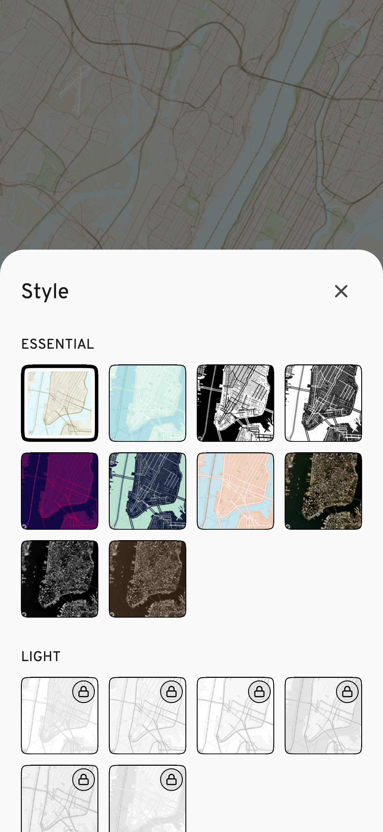 WMap Style screen on iPhone: a white sheet over a dimmed map showing a grid of map style thumbnails, with the selected style highlighted and locked styles in the Light section marked with padlocks